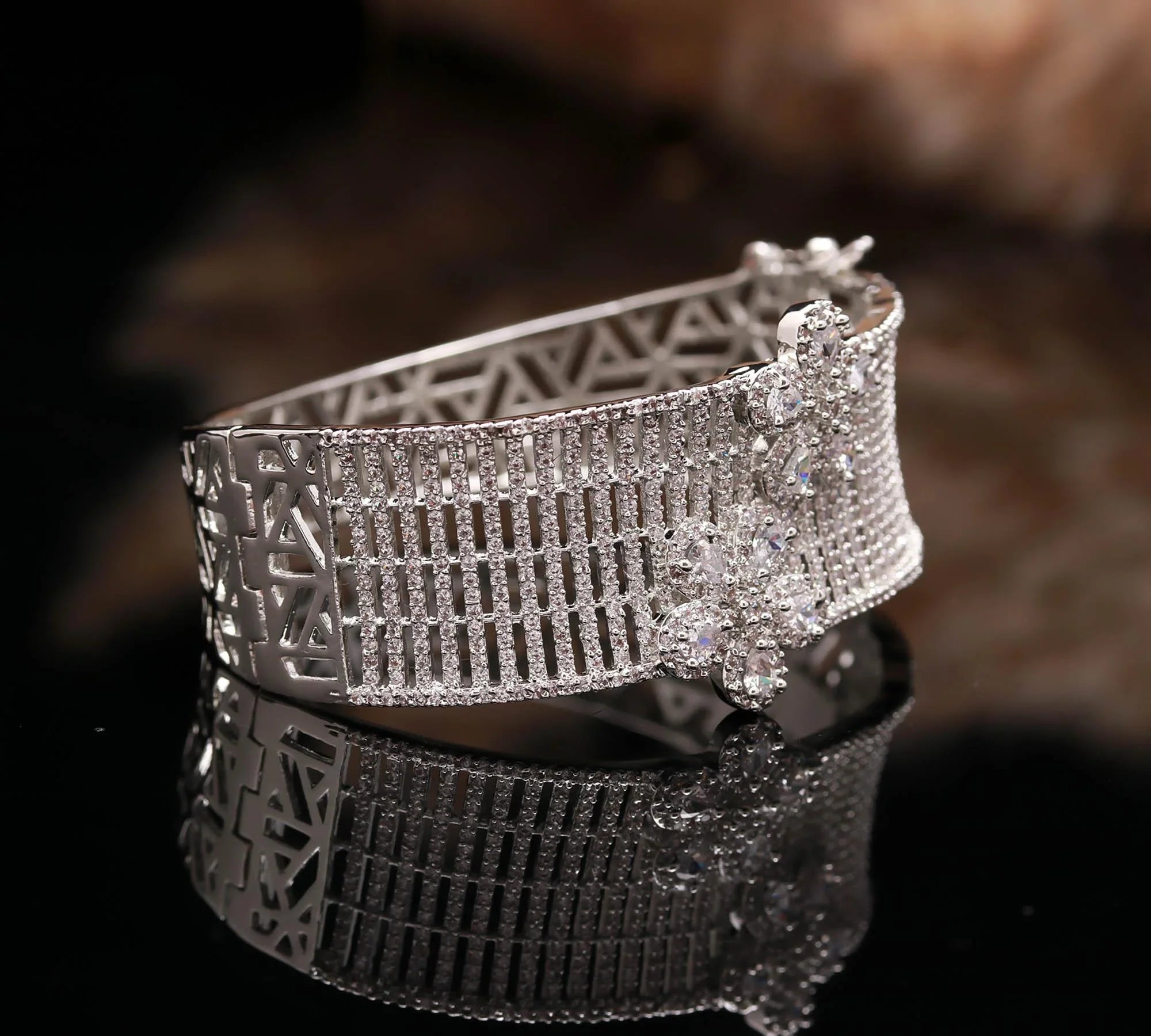 Haamsi silver bracelet with intricate geometric patterns and sparkling flower-shaped crystals