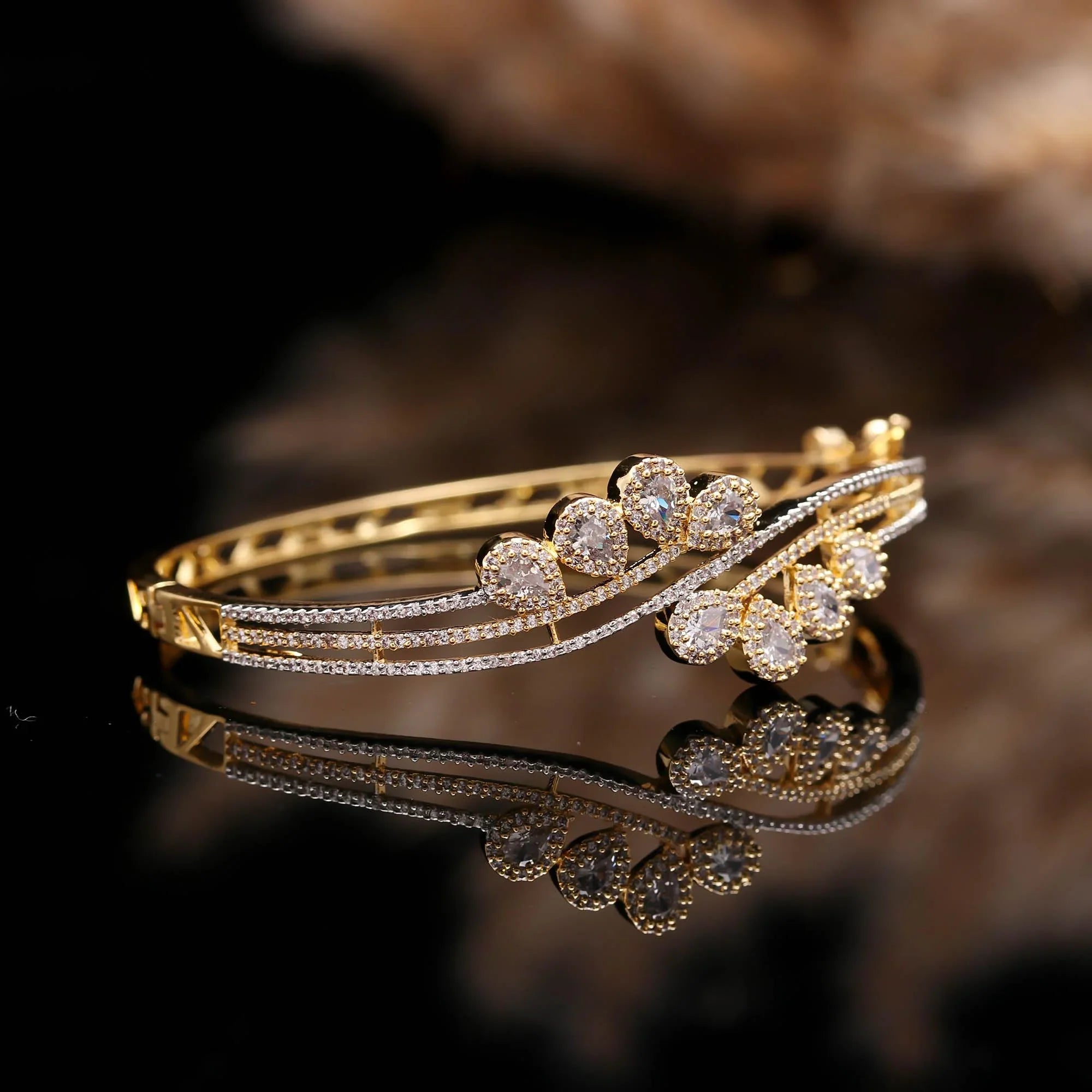 Elegant gold plated bangle bracelet with pear-shaped clear CZ stones for women, ideal for weddings and parties